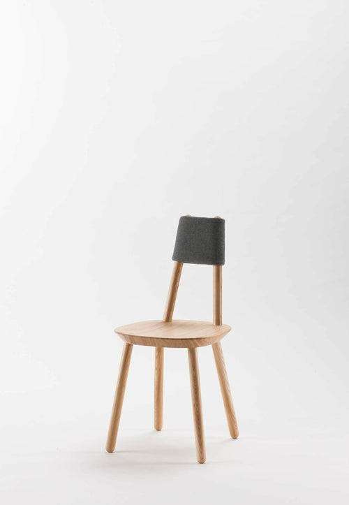 Naïve dining chair by Aquamarine Poppy featuring a modern design with wooden legs and a comfortable upholstered seat.