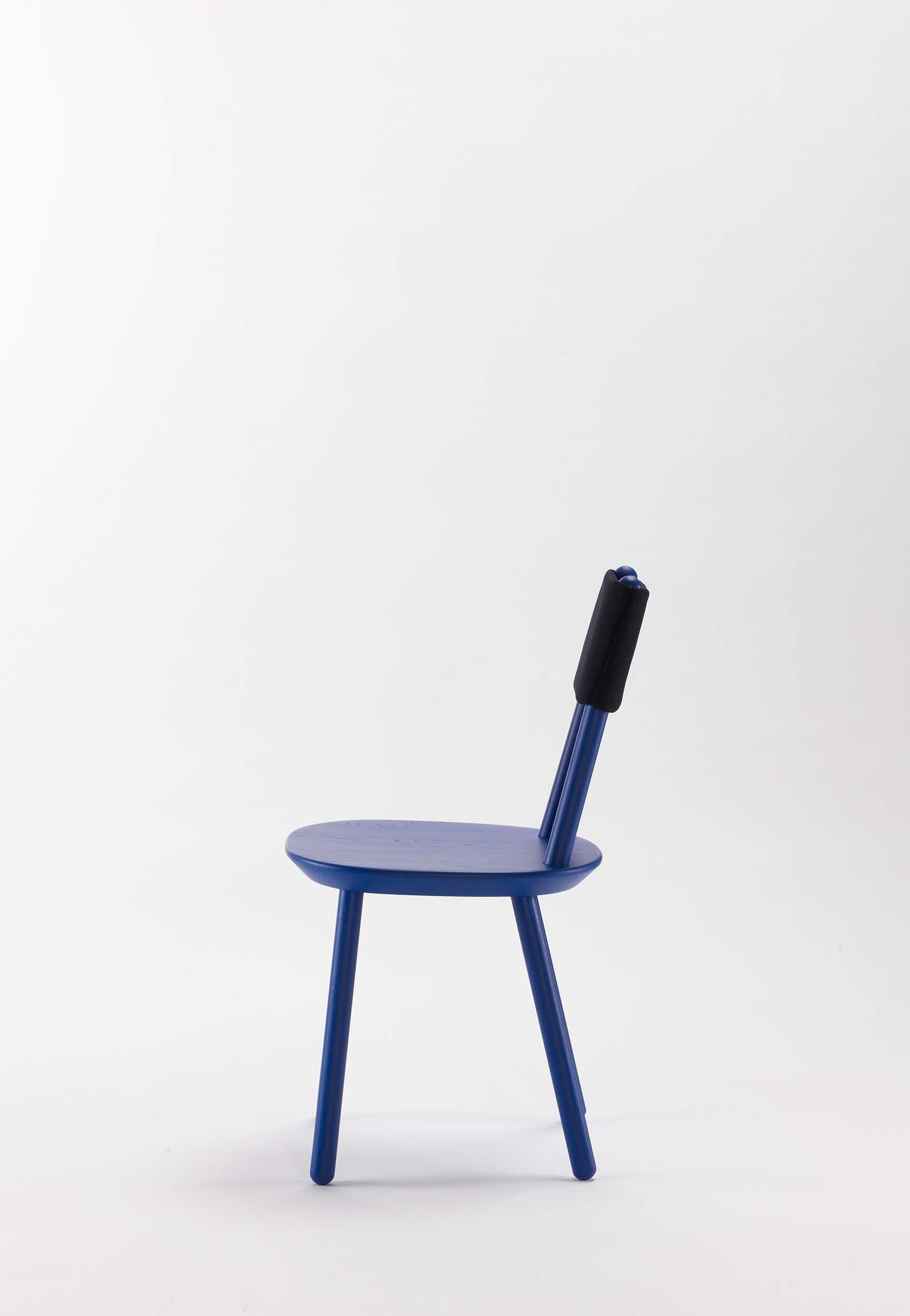 Aquamarine Poppy Naïve Dining Chair with blue upholstered seat and wooden legs, modern furniture design.