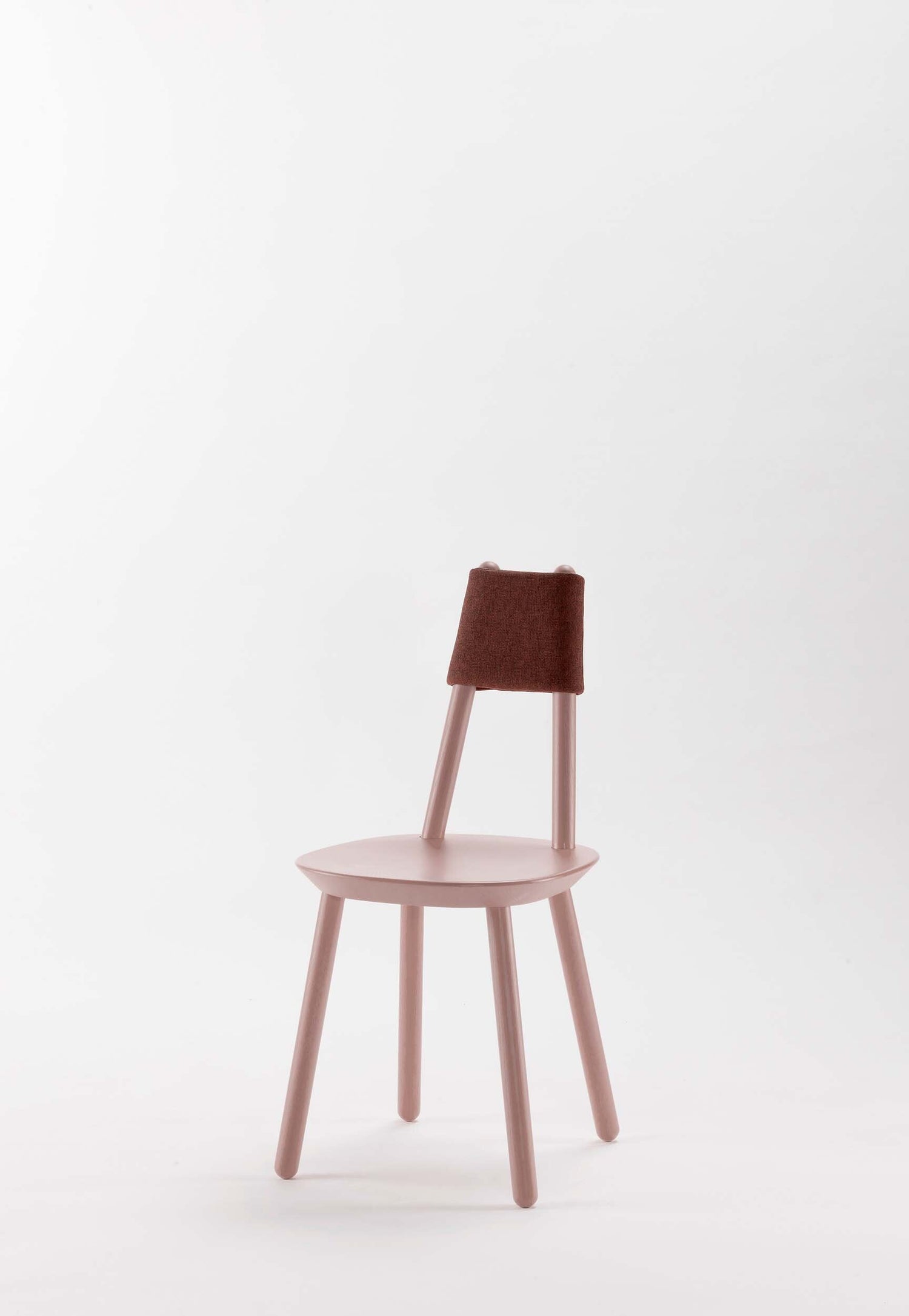 Naïve pink dining chair by Aquamarine Poppy featuring a soft fabric cushion and modern wooden frame.
