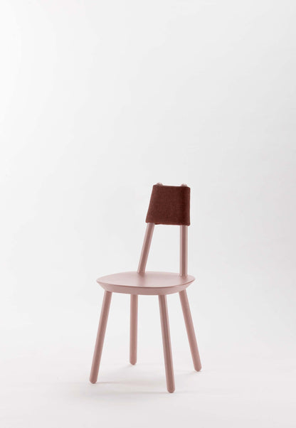 Naïve pink dining chair by Aquamarine Poppy featuring a soft fabric cushion and modern wooden frame.