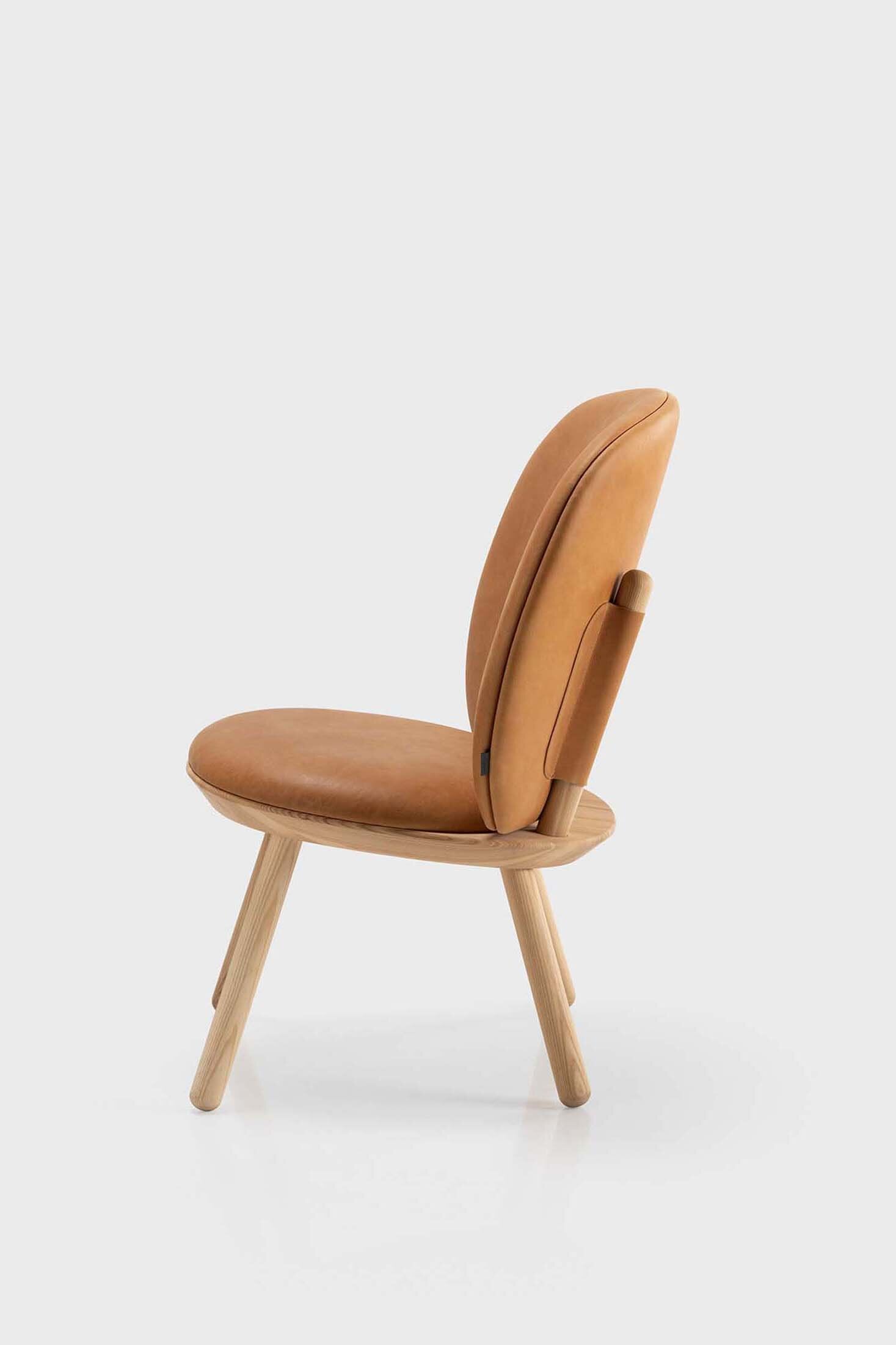 Aquamarine Poppy Naïve Low Chair in cognac leather with a modern, minimalist design and wooden legs.