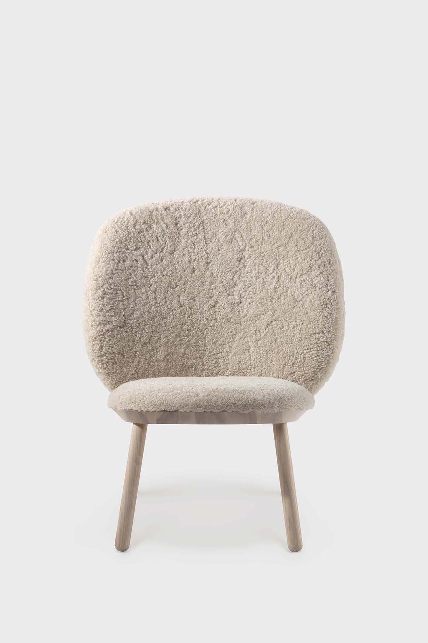 Aquamarine Poppy Naïve Low Chair with soft fabric upholstery and a modern, minimalist design showcasing a comfortable seating area.