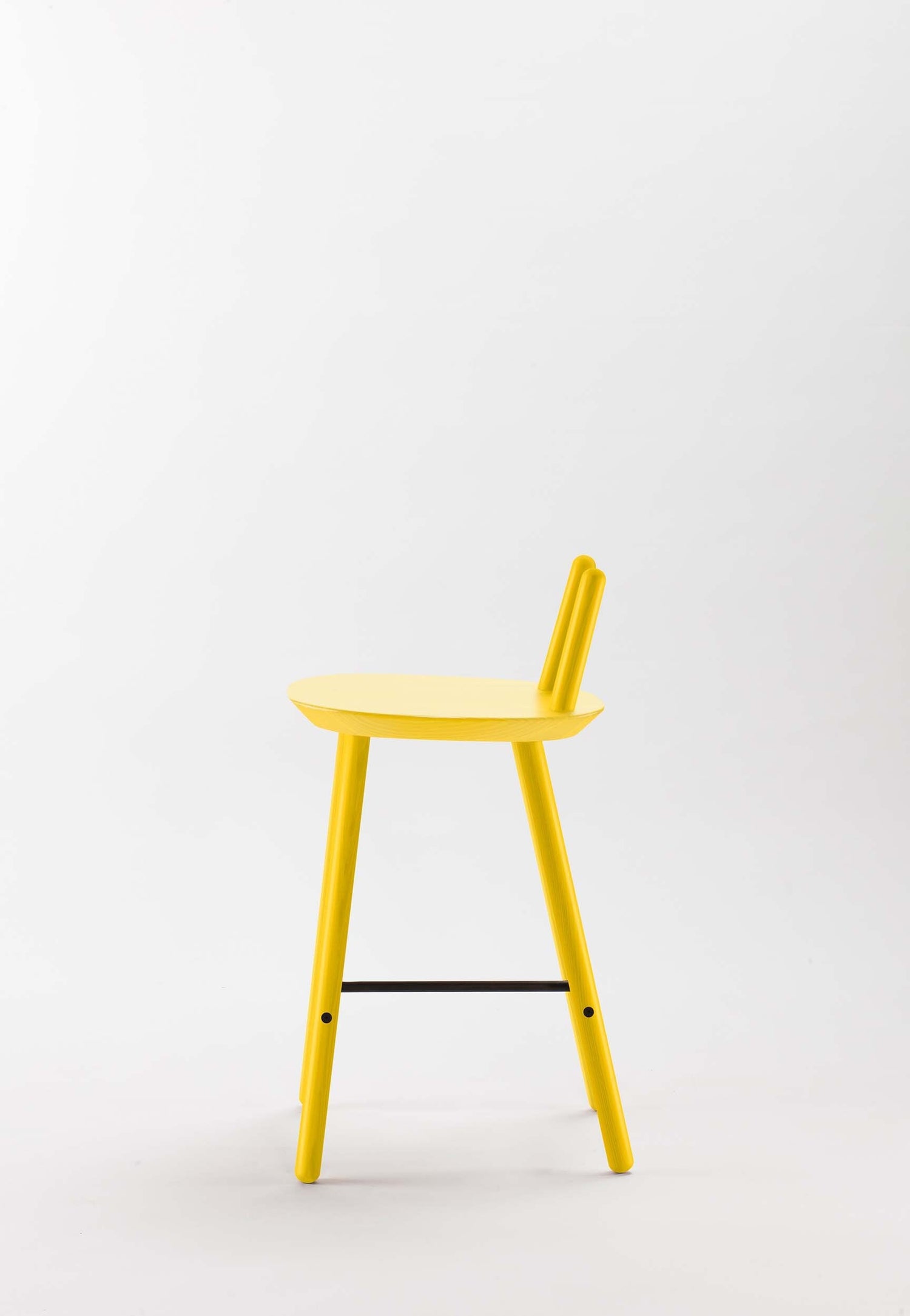 Yellow Naïve Semi Bar Stool by Aquamarine Poppy, showcasing its modern design and cushioned seat with wooden legs.