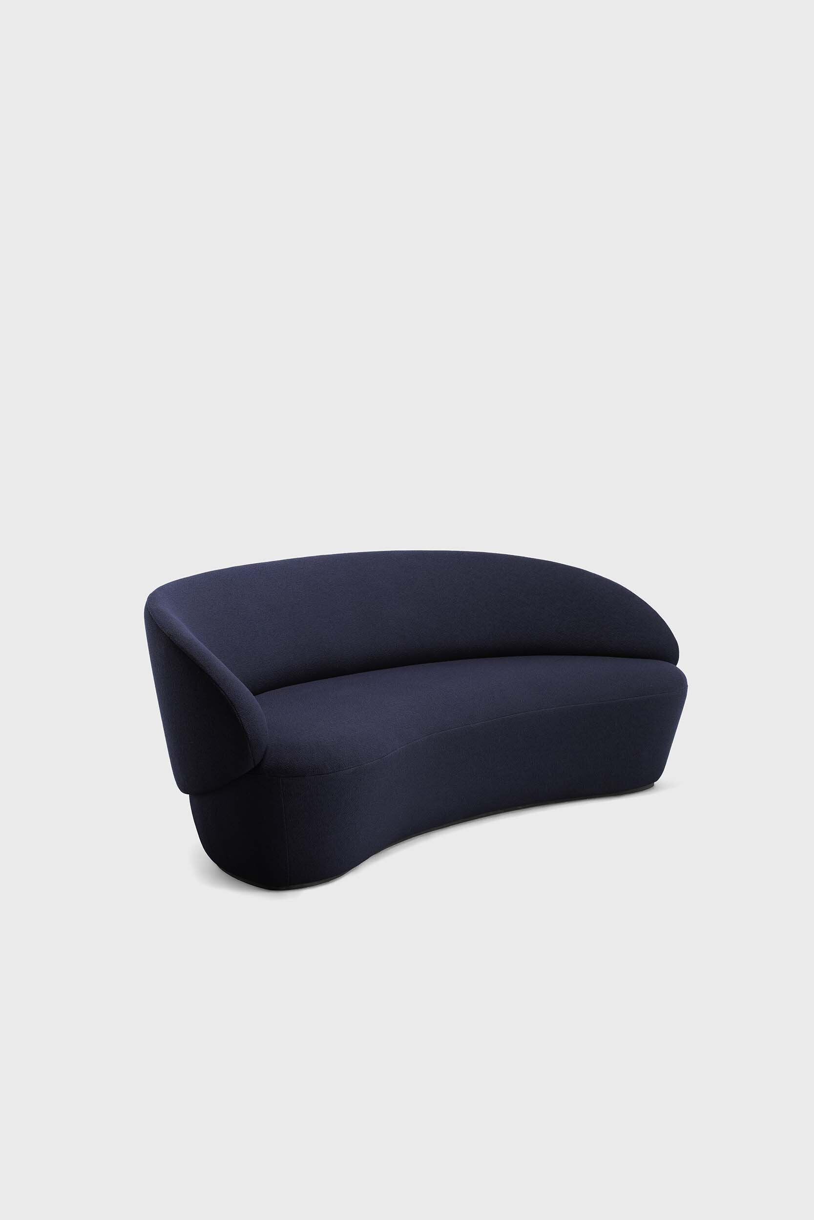 Aquamarine Poppy Naïve Sofa in soft blue fabric with plush cushions and modern design, placed in a cozy living room setting.