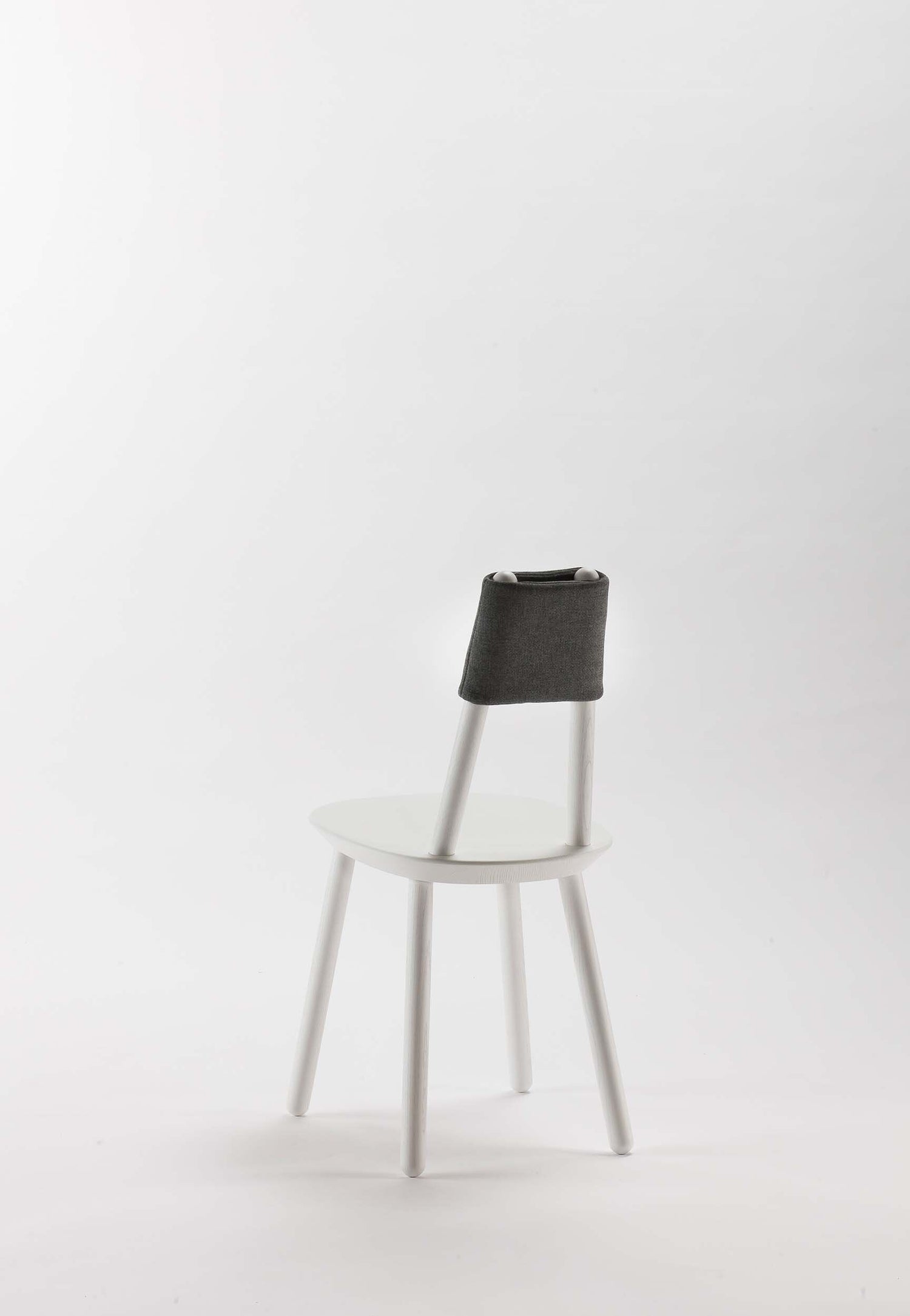 Naïve Dining Chair by Aquamarine Poppy, white furniture with a modern, minimalist design and wooden legs.