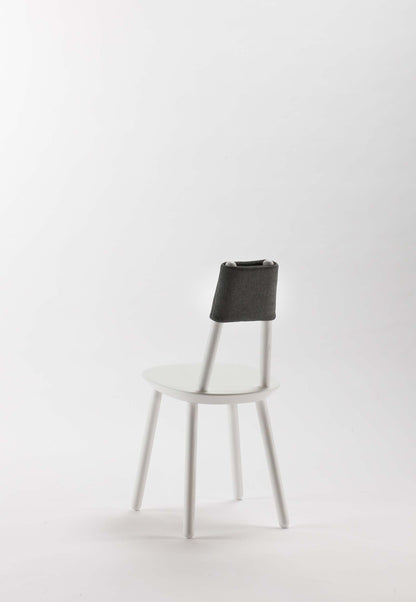 Naïve Dining Chair by Aquamarine Poppy, white furniture with a modern, minimalist design and wooden legs.