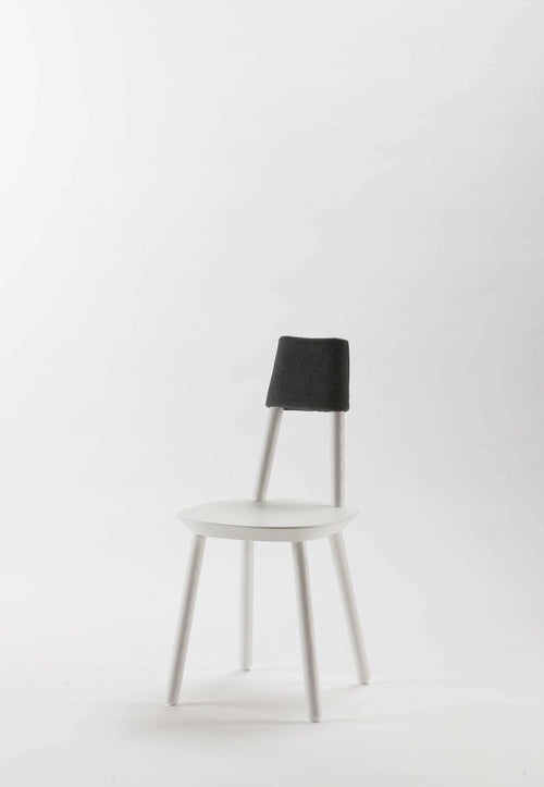White Naïve Dining Chair by Aquamarine Poppy, showcasing sleek modern furniture with smooth curves and wooden legs.