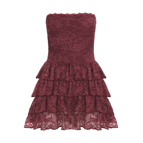 A puffy tiered summer dress by Pear Daisy with leather bra strap accents, lace stitching, and a stylish, feminine design.