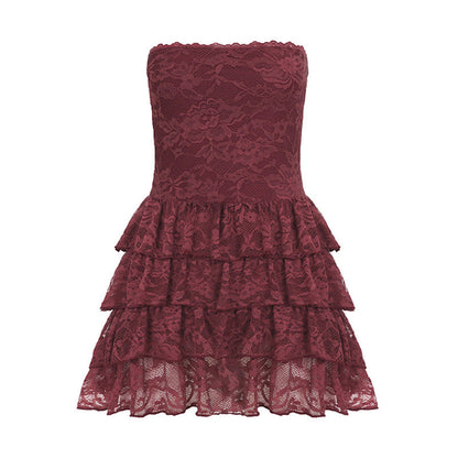 A puffy tiered summer dress by Pear Daisy with leather bra strap accents, lace stitching, and a stylish, feminine design.