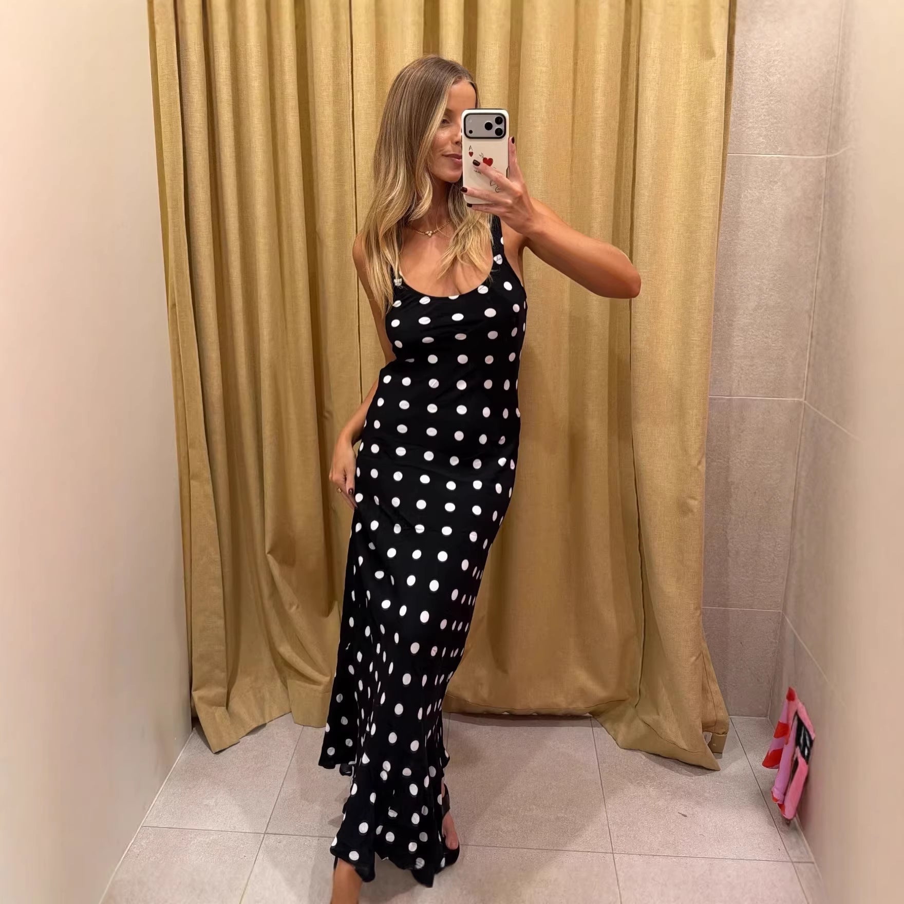 Polka dot summer dress by Pear Daisy featuring ruffled details, fitted waist, and sheath style for a stylish, summery look.