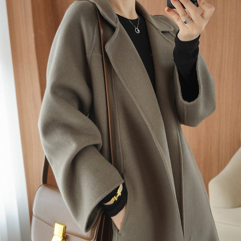 Reversible cashmere coat for women, mid-length, loose fit, over-the-knee style, by Carmine Juneberry, shown in a stylish jacket.