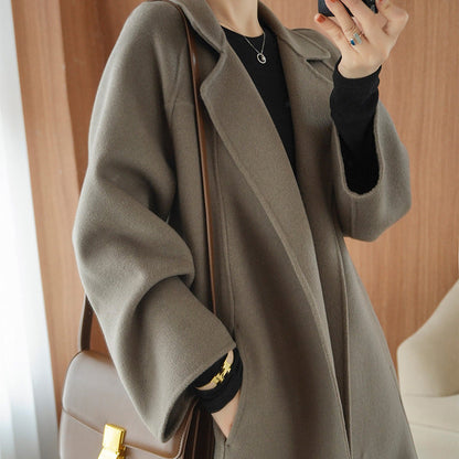 Reversible cashmere coat for women, mid-length, loose fit, over-the-knee style, by Carmine Juneberry, shown in a stylish jacket.