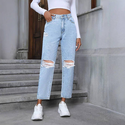 Carmine Juneberry DenimDare™ loose straight ripped denim jeans hanging on a rack with distressed details.