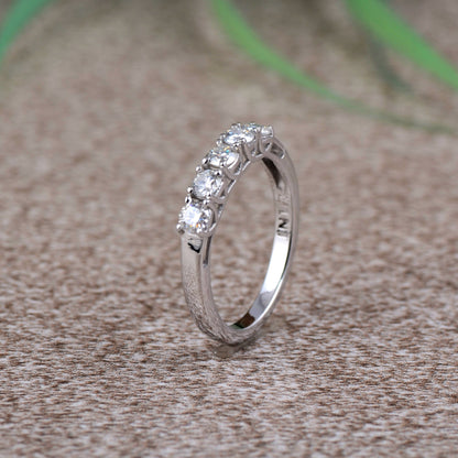 Sterling silver white moissanite 5-stone ring with sparkling gemstones, elegant jewelry piece by Copper Juniper.