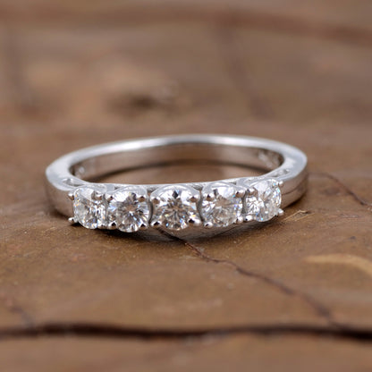 Sterling silver white moissanite 5-stone ring featuring sparkling gemstones and elegant band design.