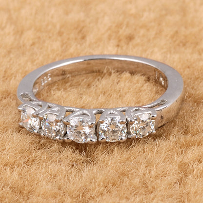 Sterling silver white moissanite 5-stone ring featuring sparkling gemstones, elegant jewelry piece from Copper Juniper.