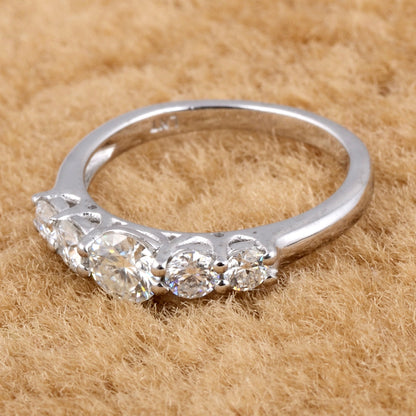 Sterling silver white moissanite 5-stone ring featuring sparkling gemstones and elegant band design.