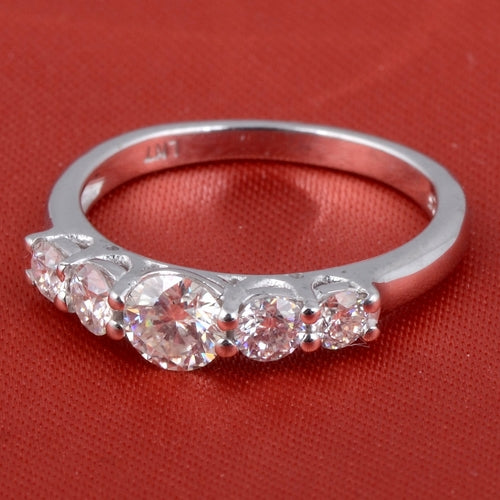 Sterling silver white moissanite 5-stone ring with sparkling gemstones, elegant jewelry design by Copper Juniper.