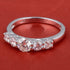 Sterling silver white moissanite 5-stone ring with sparkling gemstones, elegant jewelry design by Copper Juniper.