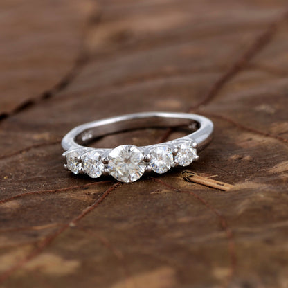 Sterling silver white moissanite 5-stone ring featuring sparkling gemstones, elegant jewelry piece from Copper Juniper.