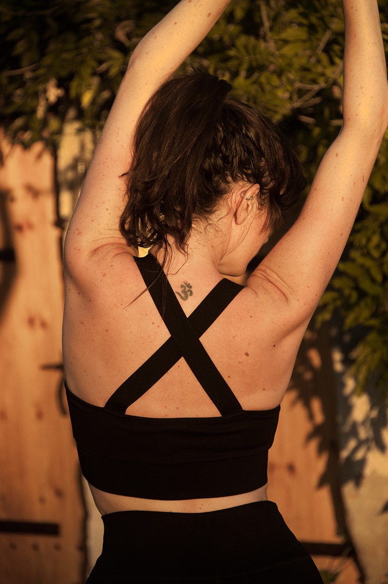 Silver Daedalus Brassière Surya lingerie in XS, soft fabric, light pink color, displayed on a flat surface with yoga attire in the background.