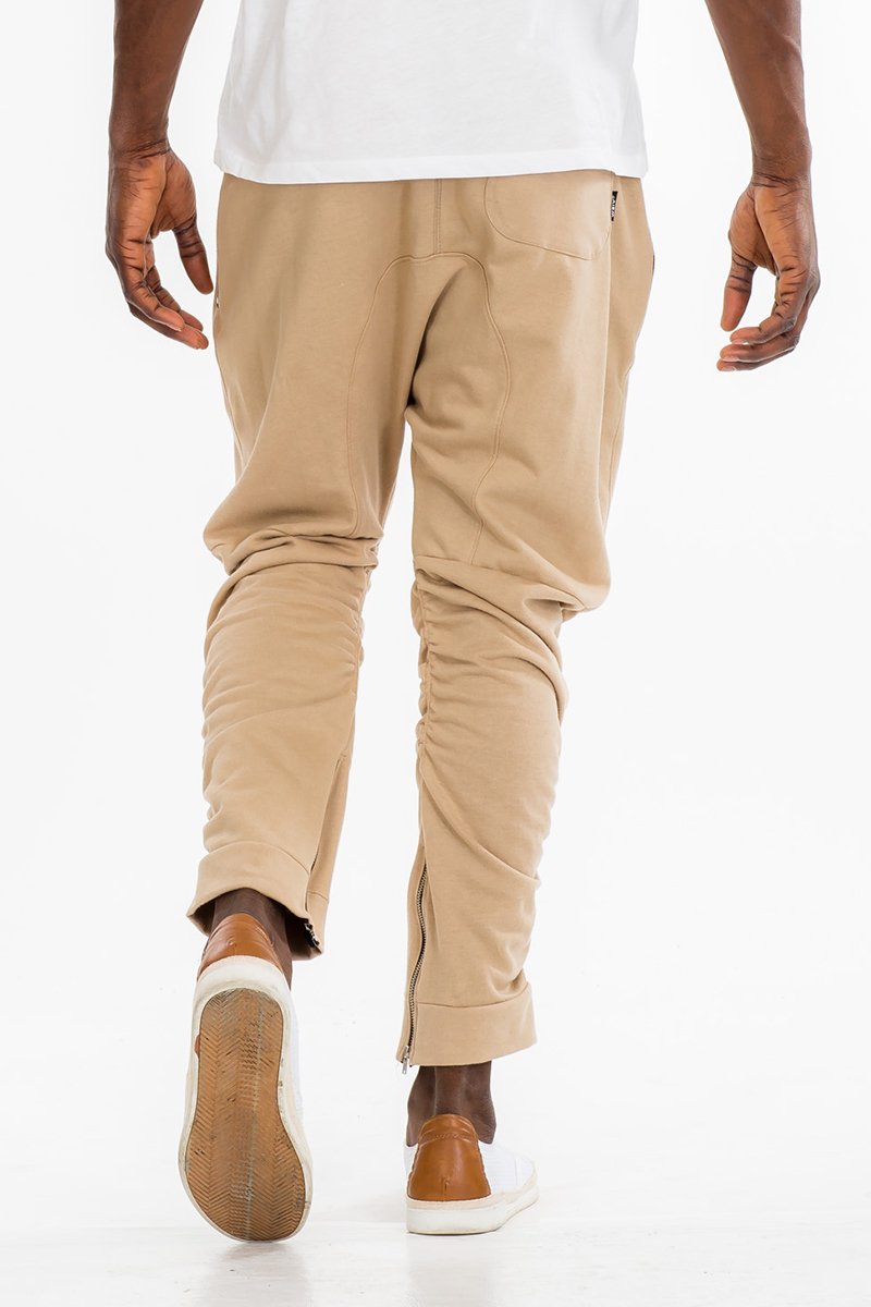 Lime Milo gathered cotton sweatpants in khaki color with a relaxed fit and elastic waistband, shown on a model.