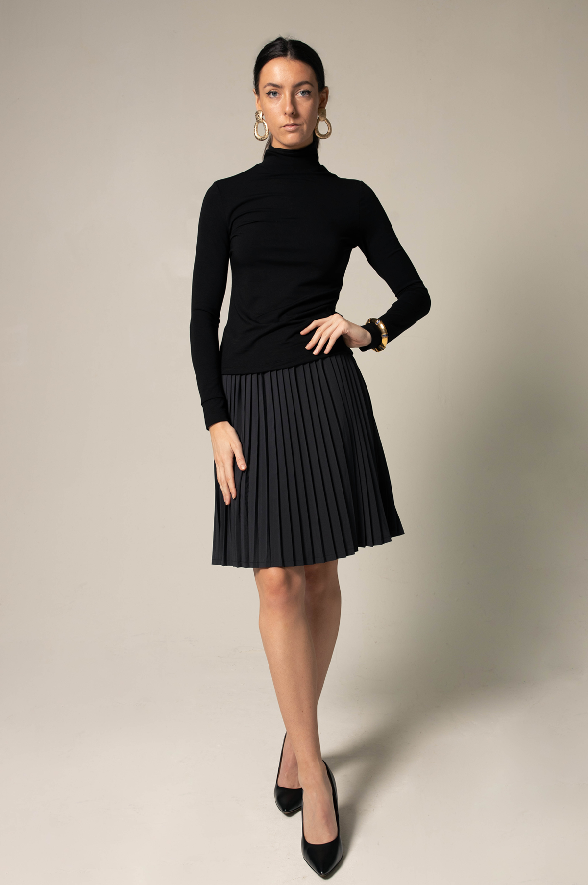 Elegant black pleated skirt for women by Mauve Daisy, featuring a chic, flowing design perfect for stylish outfits.
