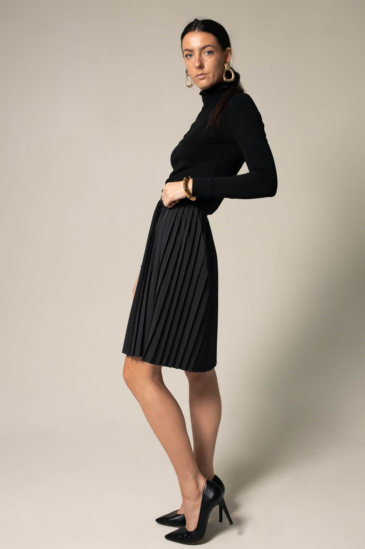 Elegant black pleated skirt for women by Mauve Daisy, showcasing a flowing, high-quality fabric with detailed pleats.