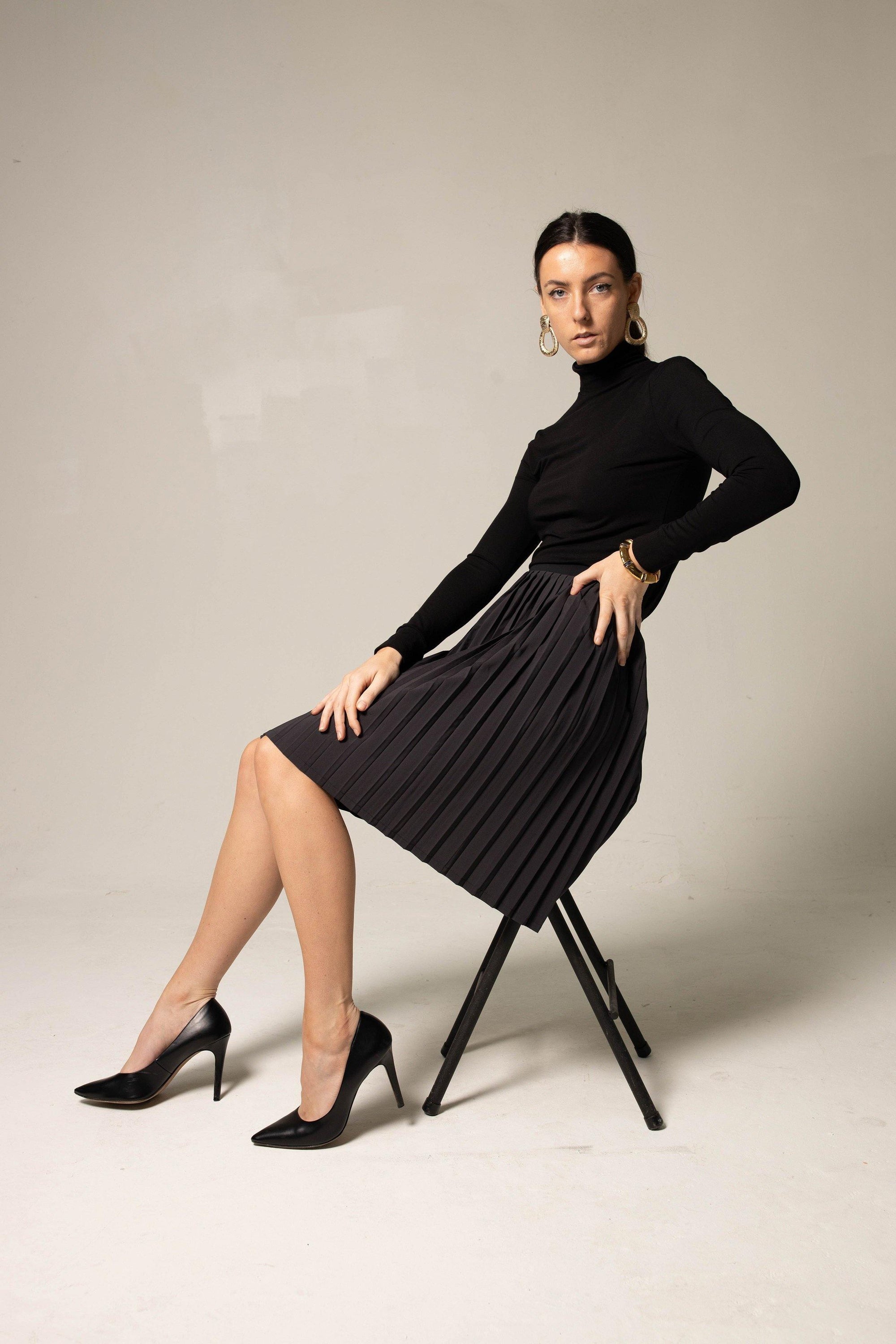 Elegant black pleated skirt for women by Mauve Daisy, showcasing a flowy, stylish design with fine pleats and a comfortable fit.