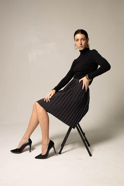 Elegant black pleated skirt for women by Mauve Daisy, showcasing a flowy, stylish design with fine pleats and a comfortable fit.