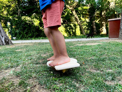 Red Oceanus Maze Wooden Balance Board, a natural wooden furniture piece with a curved design for stability and balance.