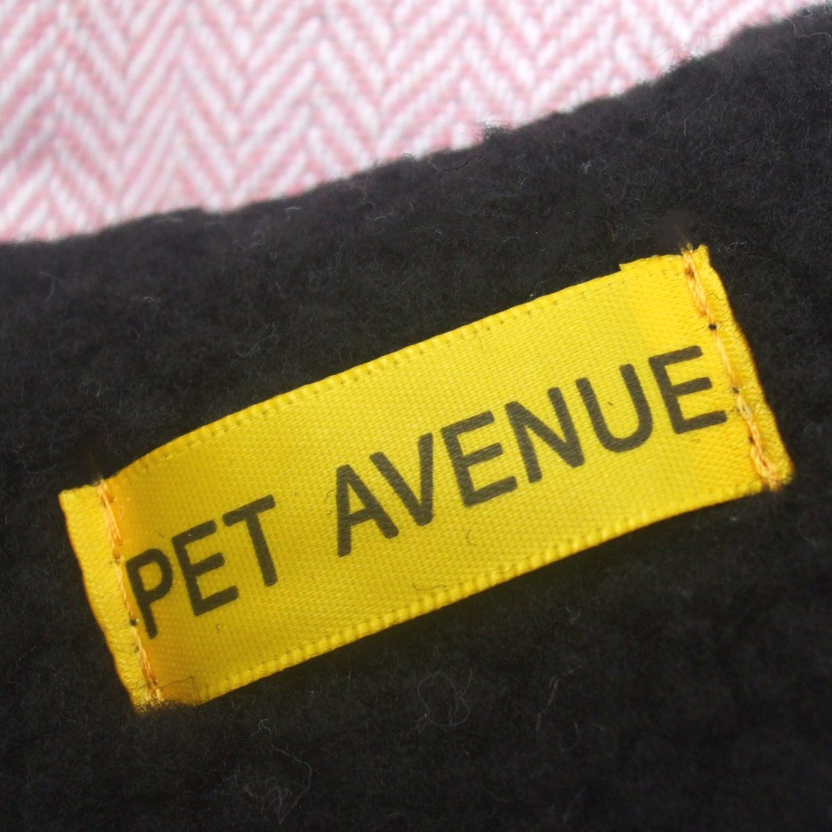 Pink herringbone dog coat by Salmon Oscar, stylish petwear with a pink label, designed for comfort and fashion.