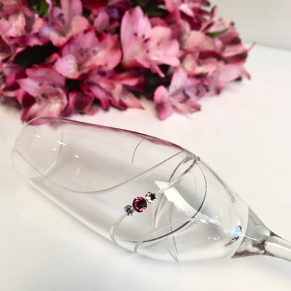 Set of two Crimson Shadow pink ribbon champagne glasses in a gift box, elegant drinkware for celebration.