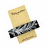 Silver feather hair barrette on black leather, stylish hair accessory by Orange Themis for elegant hair styling.