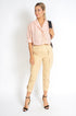 Beige pleated capri pants for women by Azure Thanatos, featuring a tailored fit and stylish design.