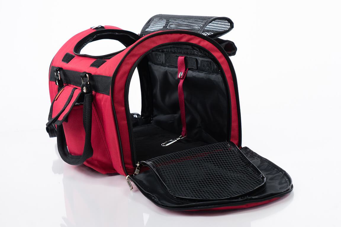 Pink Coconut 312 Hideaway™ Duffel pet carrier in burgundy, side view showing breathable mesh sides and comfortable carrying handle.