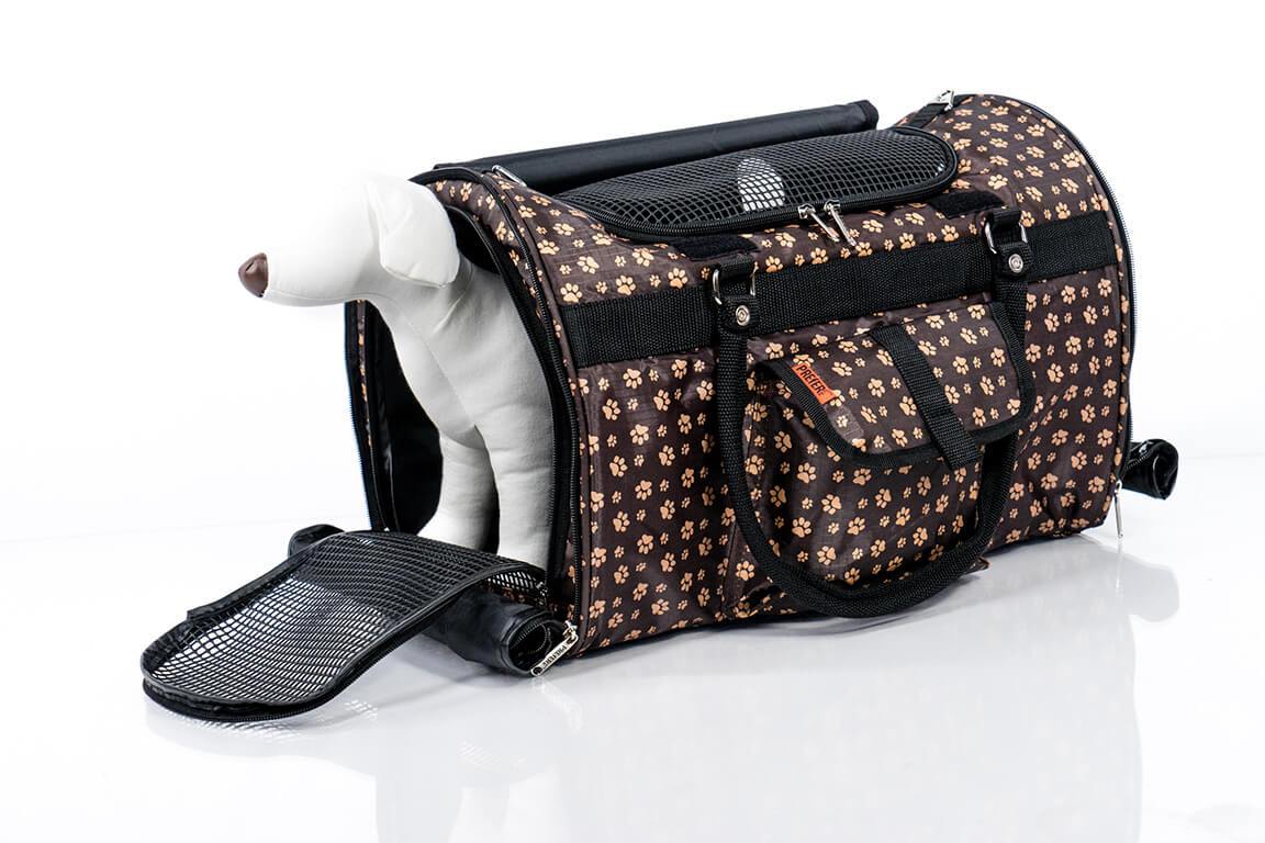 Pink Coconut 312 Hideaway™ Duffel pet carrier with paw print design, side view showing open door and small dog inside.