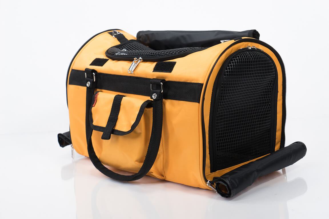 Pink Coconut 312 Hideaway™ Duffel pet carrier in tangerine, side view showing breathable mesh panels and sturdy handles.