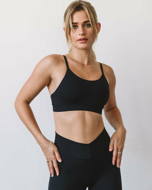 Black Cammie Cloudlux bra by Lemon Molly, showcasing smooth fabric and comfortable fit on a woman’s upper body.