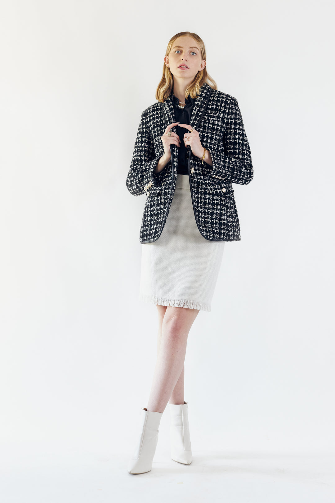 Luxe white mini tweed skirt for women by Mauve Daisy, showcasing a chic, textured design perfect for stylish outfits.