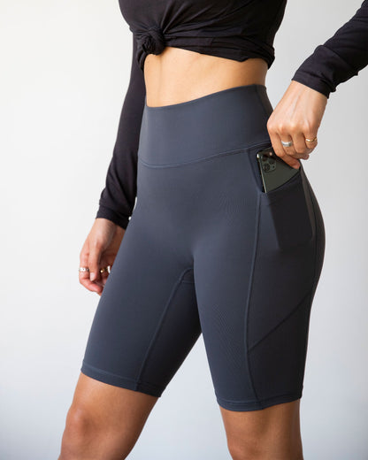 Lemon Molly Making Moves Pocket Biker Shorts 8.5-inch in smoke color, showing side view with pockets and fitted design for women.