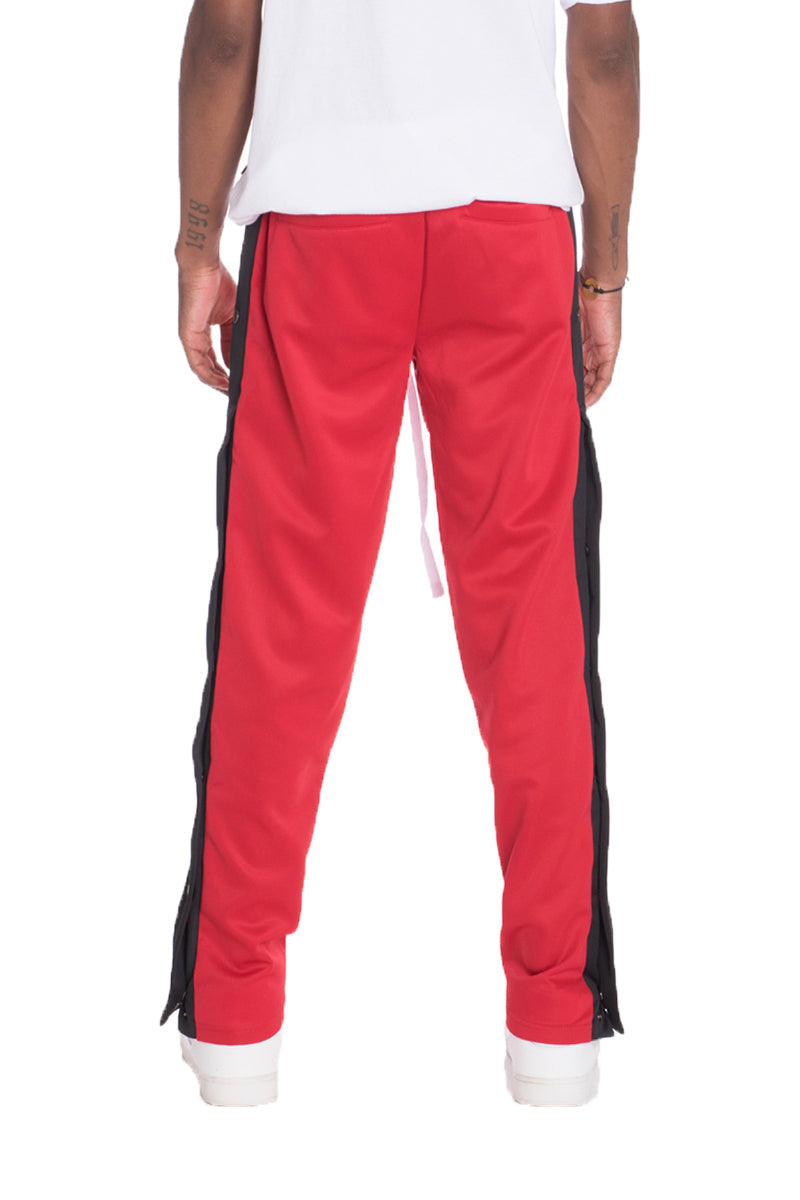 Red Lime Milo Snap Button Track Pants with elastic waistband and side pockets, featuring snap button details.