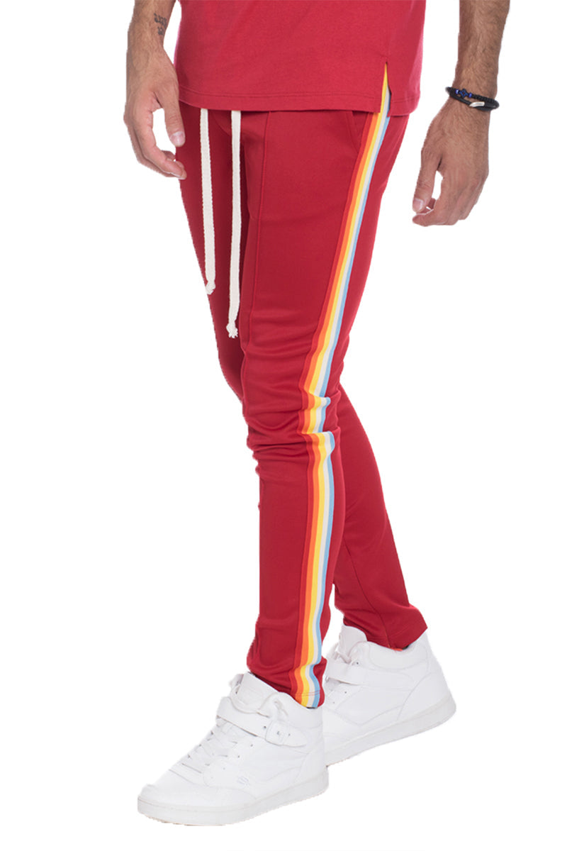 Lime Milo full rainbow track pants in vibrant red with colorful stripe details, casual athletic pants for active wear.