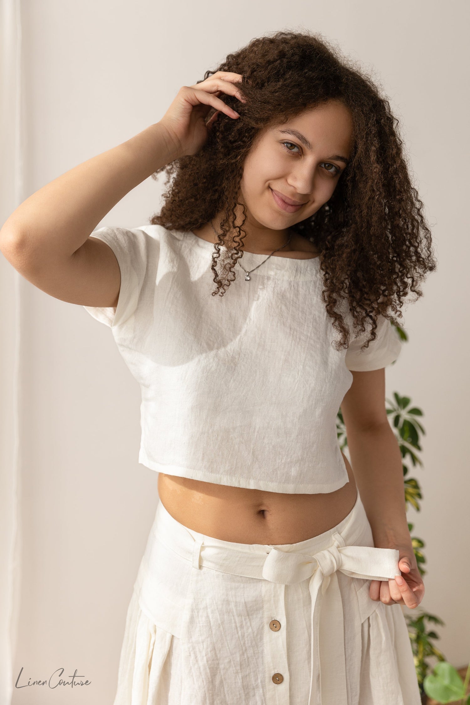 Magenta Sugarplum Taormina linen crop top and flared midi skirt matching set in natural fabric, styled together on a model.