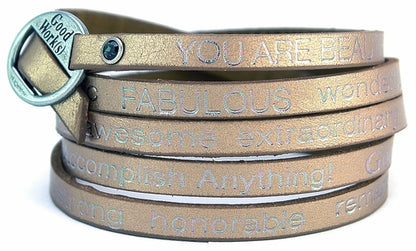 Bronze wrap-around bracelet labeled "Peaceful" from Orange Eunostus, featuring a stylish design and meaningful "You Are Beautiful" message.