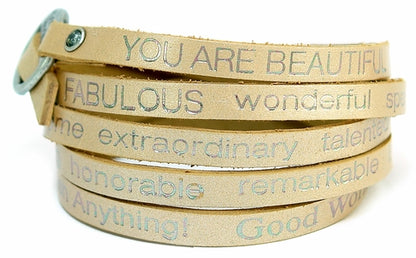 Gold wrap-around bracelet with "You Are Beautiful" inscription by Orange Eunostus, featuring a peaceful, elegant design.