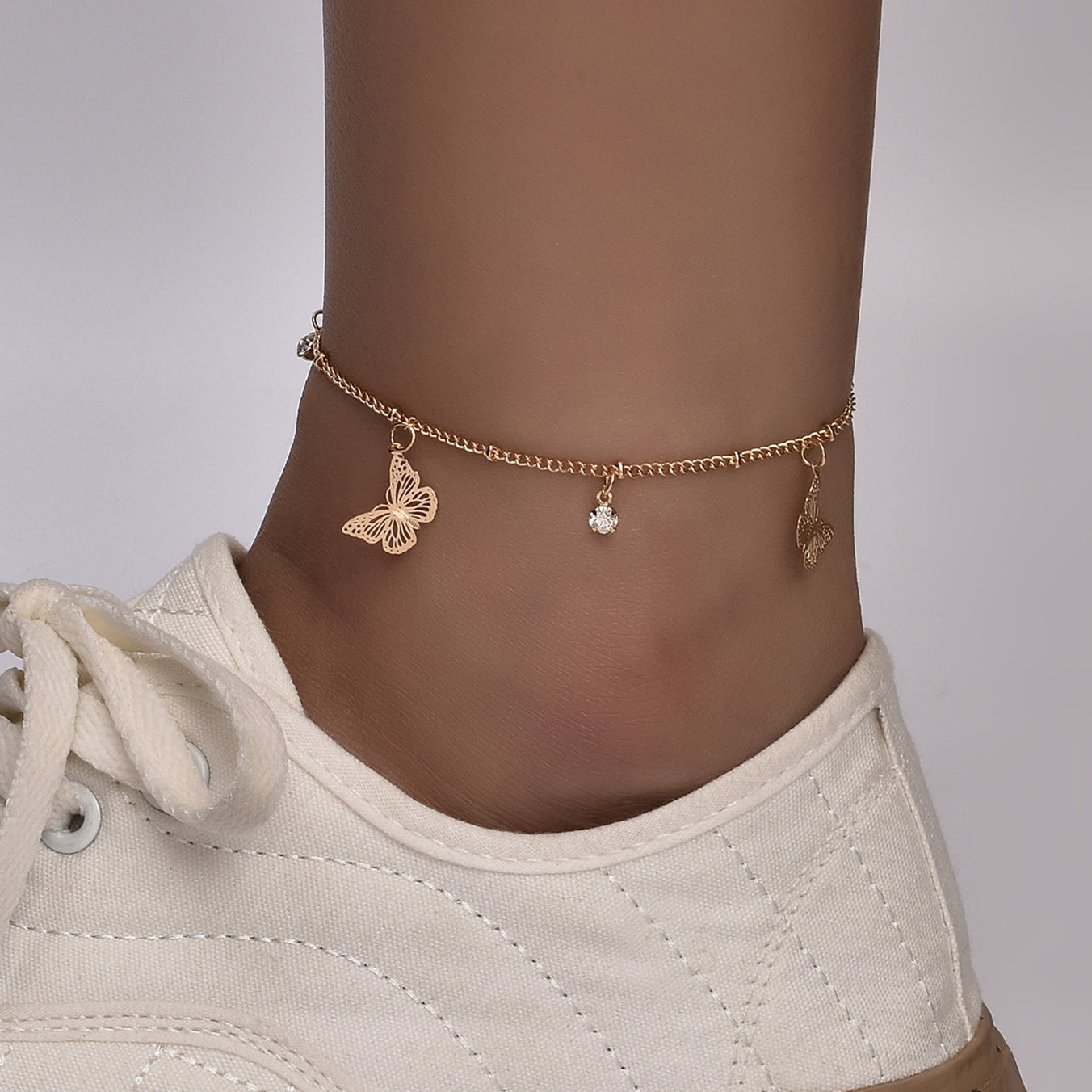 Silver plated Butterfly Bohemia ankle bracelet with delicate chain and butterfly charm, stylish accessory by Red Iphigenia.