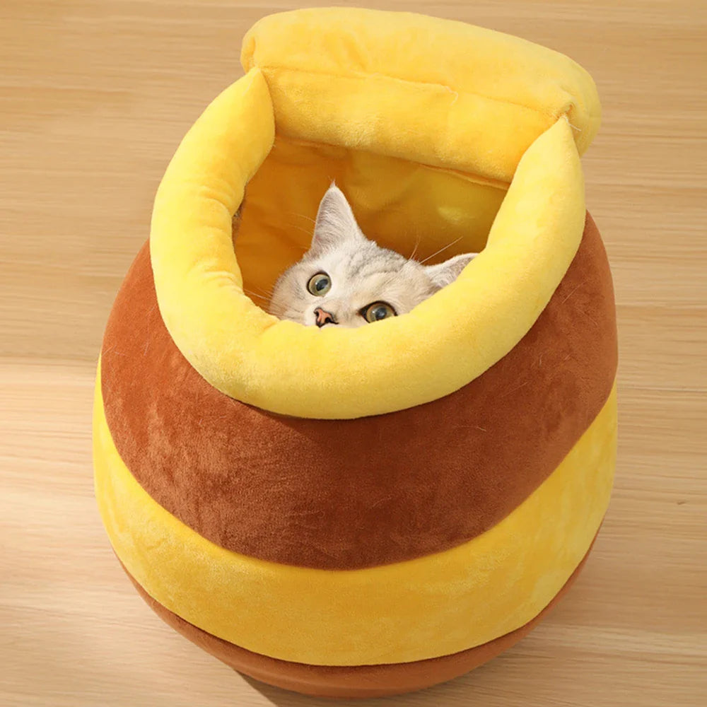 Yellow Pandora honey jar themed cat bed with soft fabric and cozy interior, designed for comfortable feline relaxation.