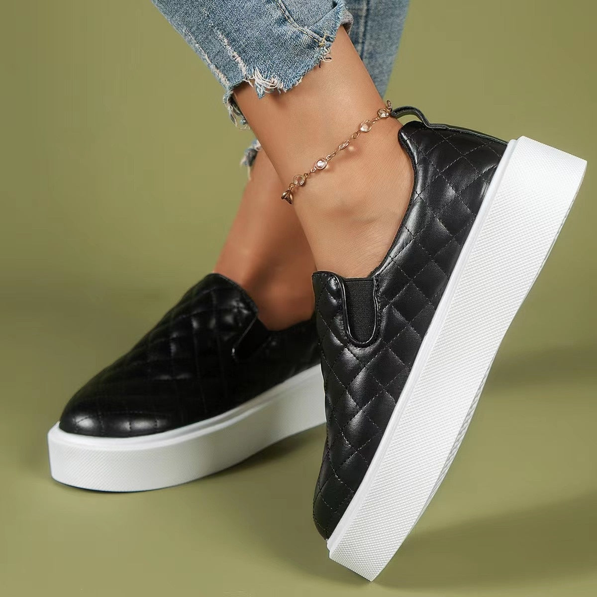 Black and white lightweight slip-on platform loafers from Coffee Jasper, casual sneakers with a sleek, flat design.