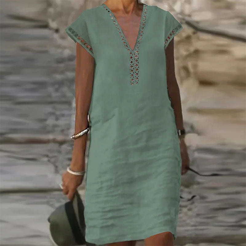 Elegant cotton linen dress by Yellow Eleusis, displayed with a stylish bag, featuring natural fabric textures and classic design details.